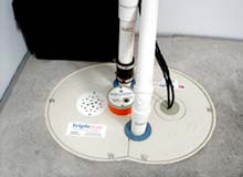 Photograph of sumbersible sump pump installed in a basement floor